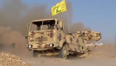 A still image taken on July 21, 2017 from an undated footage by Hezbollah Military handout shows a weapon being fired from the back of a truck with a Hezbollah flag on it at an unidentified location at the Syrian-Lebanese frontier. Hezbollah Military/Handout via Reuters TV.