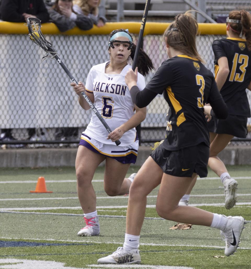 Jackson’s Catalina Gonzalez looks to pass in front of Upper Arlington’s Kyle Baugh on Saturday, April 2, 2022.