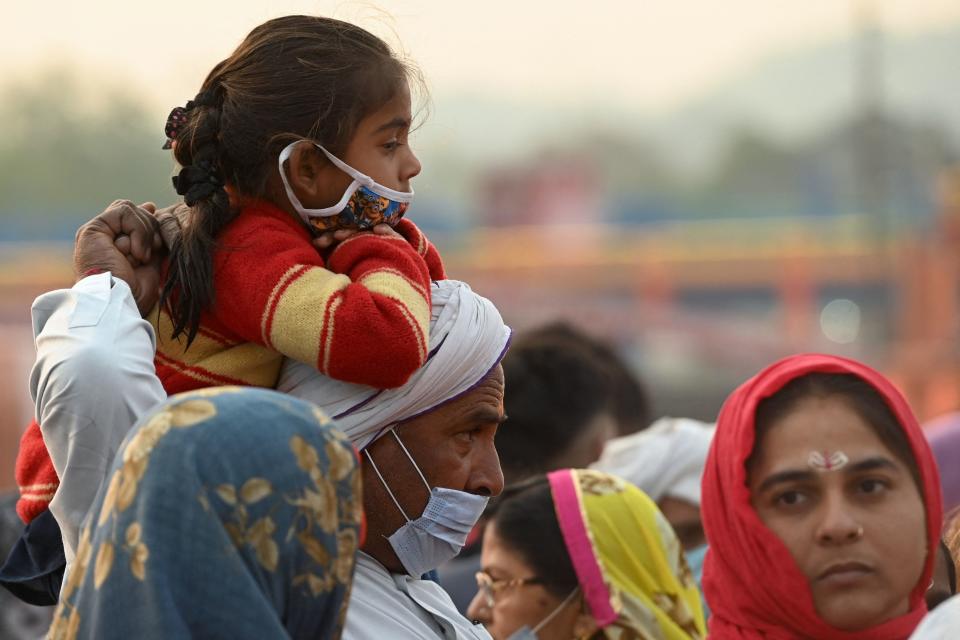 Hindu devotees gather on the banks of the Ganges River on the day of Shahi Snan (Royal Bath) during the ongoing religious Kumbh Mela festival, in Haridwar on April 12, 2021. (Photo by Money SHARMA / AFP) (Photo by MONEY SHARMA/AFP via Getty Images)