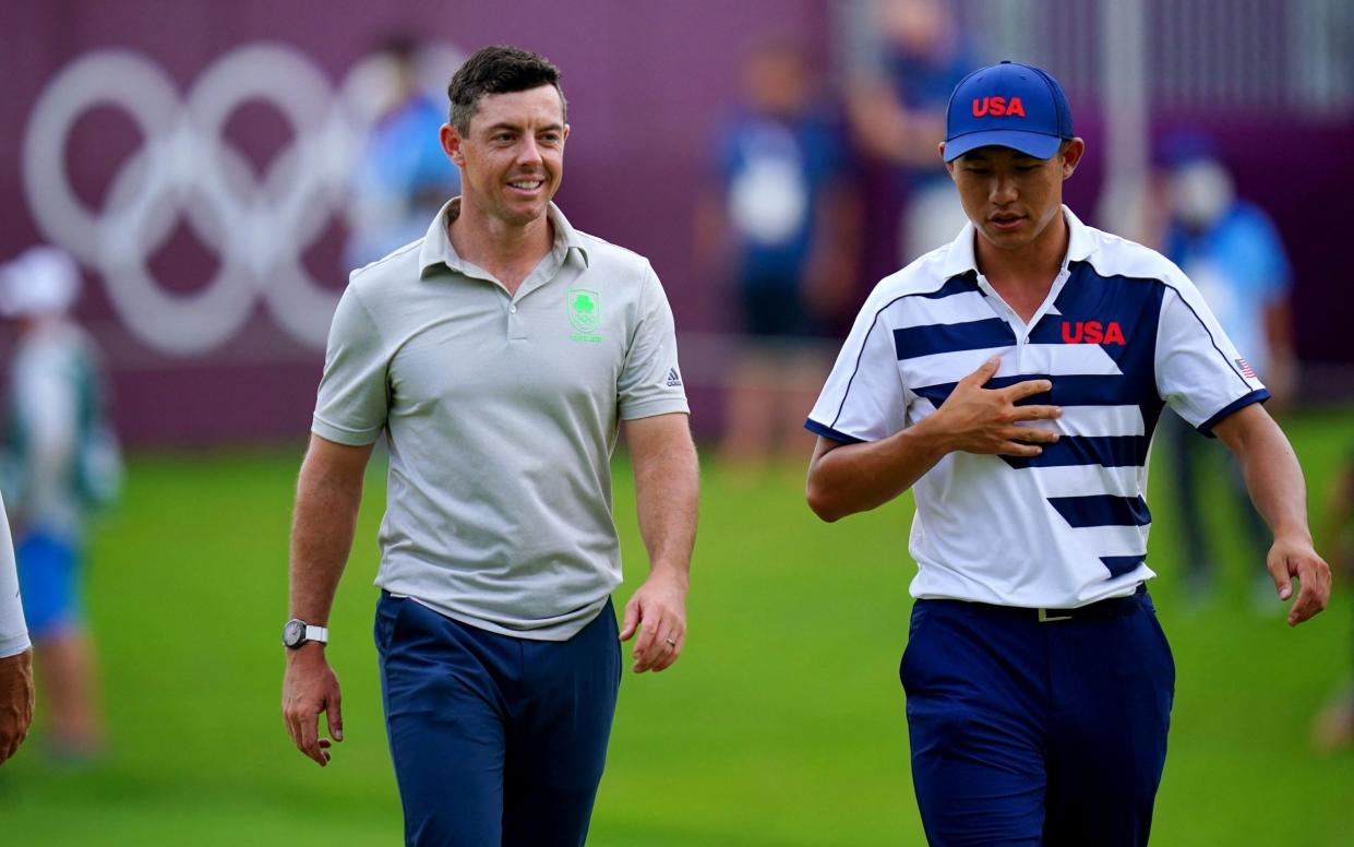 Ireland's Rory Mcilroy (L) and USA's Collin Morikawa (R) walk after hole out in round 1 of the mens golf individual stroke play during the Tokyo 2020 Olympic Games at the Kasumigaseki Country Club in Kawagoe on July 29, 2021 - GETTY IMAGES