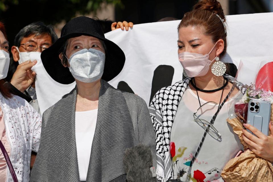 Fusako Shigenobu, left, who co-founded the terrorist group Japanese Red Army, with her daughter Mei, speaks to journalists after she walked out of prison in Tokyo’s Akishima suburb on 28 May (AP)