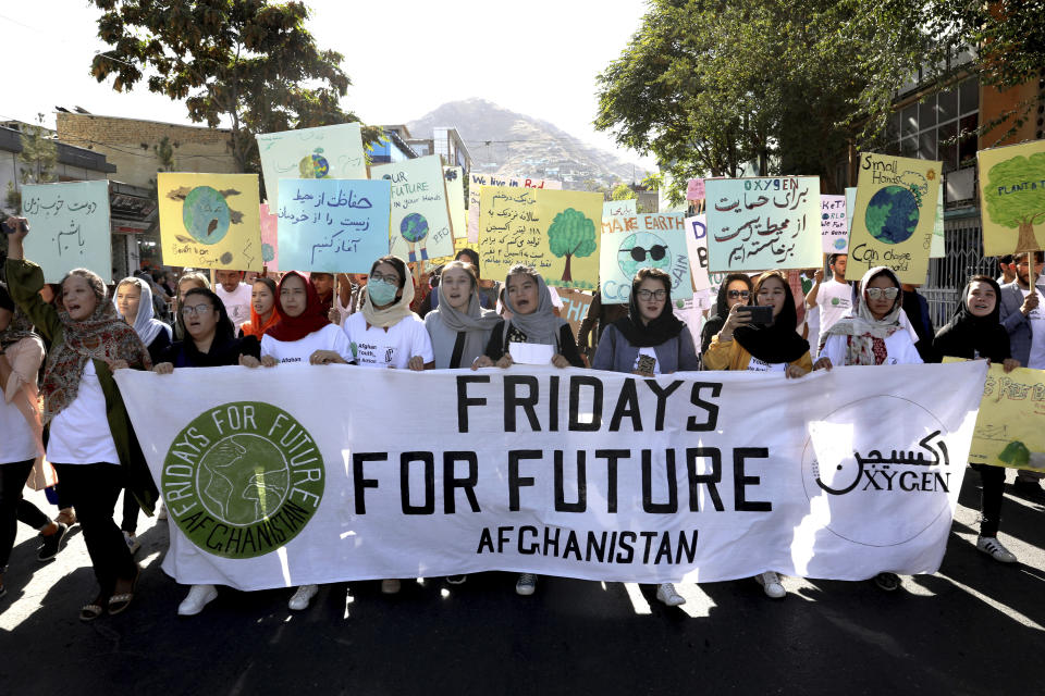 Young people attend a Climate Strike rally, in Kabul, Afghanistan, Friday, Sept. 20, 2019. In the Afghan capital, where people are dying every day in horrific bomb attacks, a young generation, worried that if war doesn't kill them climate change will, took part in the global climate strike. (AP Photo/Ebrahim Noroozi)