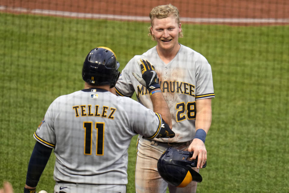 Milwaukee Brewers' Joey Wiemer (28) returns to the dugout after scoring on a double by Christian Yelich off Pittsburgh Pirates starting pitcher Osvaldo Bido during the third inning of a baseball game in Pittsburgh, Friday, June 30, 2023. (AP Photo/Gene J. Puskar)
