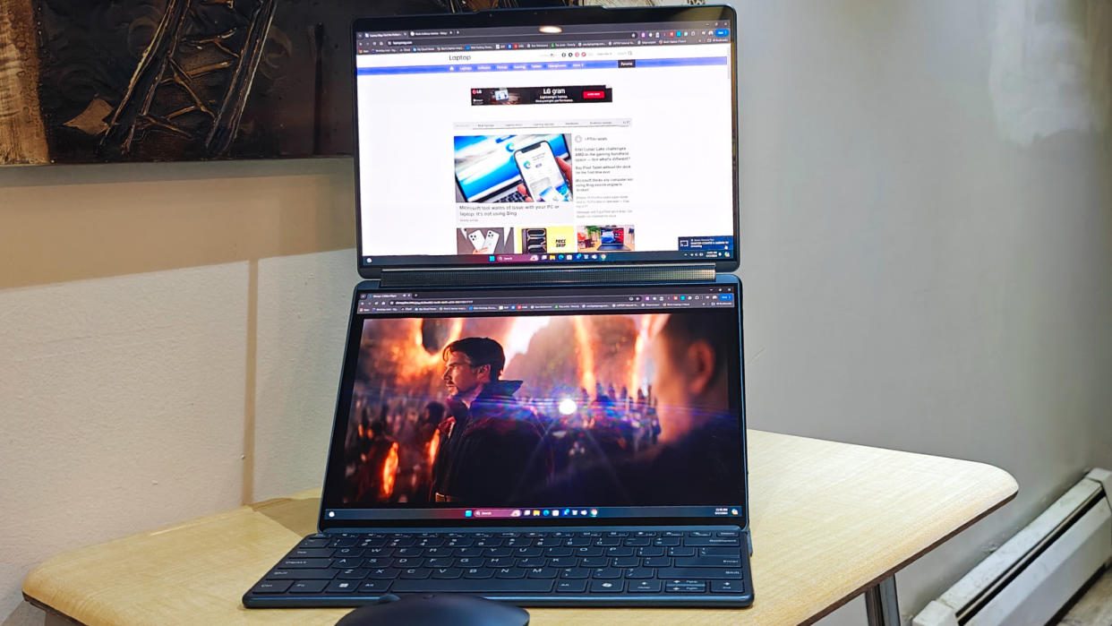  Lenovo Yoga Book 9i Gen 2 unfolded on a desk to show the dual-screens. 