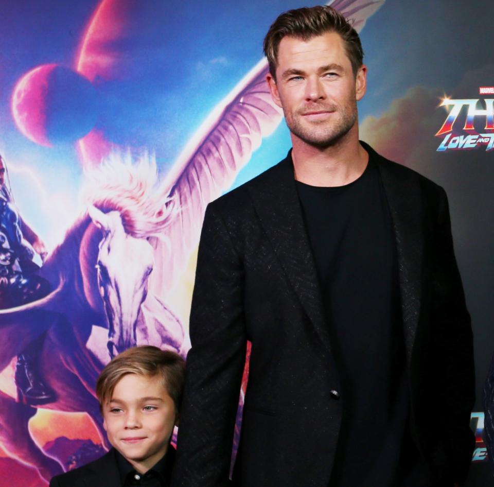 Chris Hemsworth with one of his twin sons at the Sydney premiere of Thor: Love And Thunder, in which he cameos. (Getty Images)