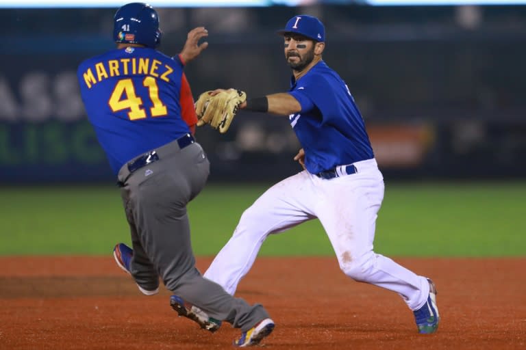 Daniel Descalso (R) of Italy tags out Victor Martinez of Venezuela in the top of the fifth inning during their World Baseball Classic Pool D game, at Panamericano Stadium in Zapopan, Mexico, on March 13, 2017