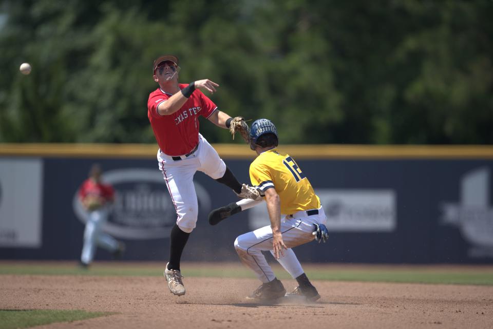 Texas Tech's Jace Jung (2) attempts to turn a double play at second base against UNC Greensboro's GC Jarman (12) during a game Saturday, June 4, 2022, in the Statesboro Regional held at J.I. Clements Stadium in Statesboro, Georgia.