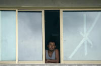 A man looks out of a window of a school that was used as a refuge from Hurricane Orlene in Escuinapa, Mexico, Monday, Oct. 3, 2022. Hurricane Orlene made landfall on Mexico's Pacific coast near the tourist town of Mazatlan on Monday before quickly weakening over western Mexico. (AP Photo/Fernando Llano)