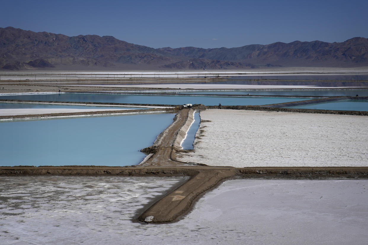 FILE - A truck is parked between brine evaporation ponds at Albemarle Corp.'s Silver Peak lithium facility, Oct. 6, 2022, in Silver Peak, Nev. The Energy Department is making a push to strengthen the U.S. battery supply chain, announcing Wednesday, Nov. 15, 2023, up to $3.5 billion for companies that produce batteries and the critical minerals that go into them. (AP Photo/John Locher, File)