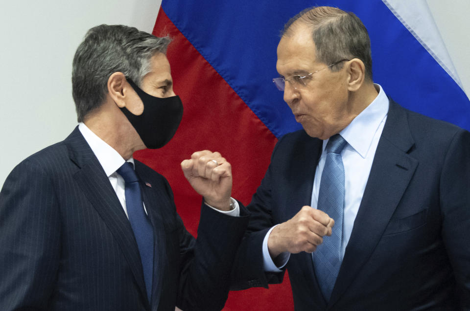 U.S. Secretary of State Antony Blinken, left, greets Russian Foreign Minister Sergey Lavrov, right, as they arrive for a meeting at the Harpa Concert Hall in Reykjavik, Iceland, Wednesday, May 19, 2021, on the sidelines of the Arctic Council Ministerial summit. (Saul Loeb/Pool Photo via AP)