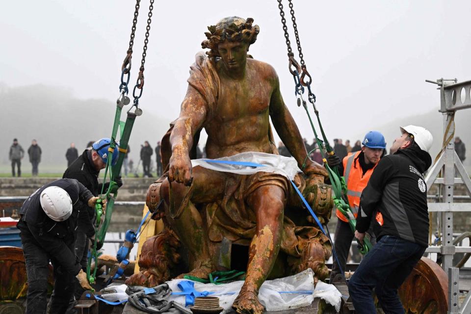 6 December 2022: The sculpted group Apollo on his Chariot is hooked before being lifted as part of the launch of the restoration of the basin of the Chariot of Appolo at the Versailles castle outside Paris (AFP/Getty)
