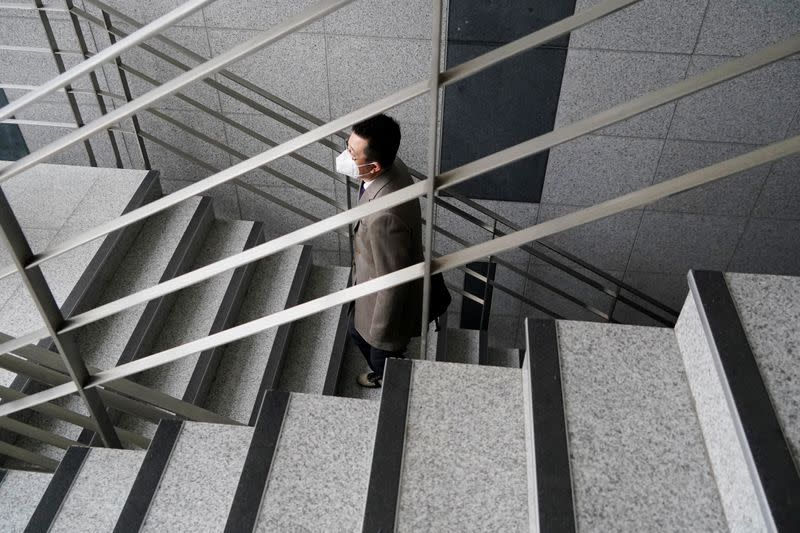 A professor of Pusan National University Park Hyun who used to be a coronavirus patient, walks up the stairs at Pusan National University in Busan