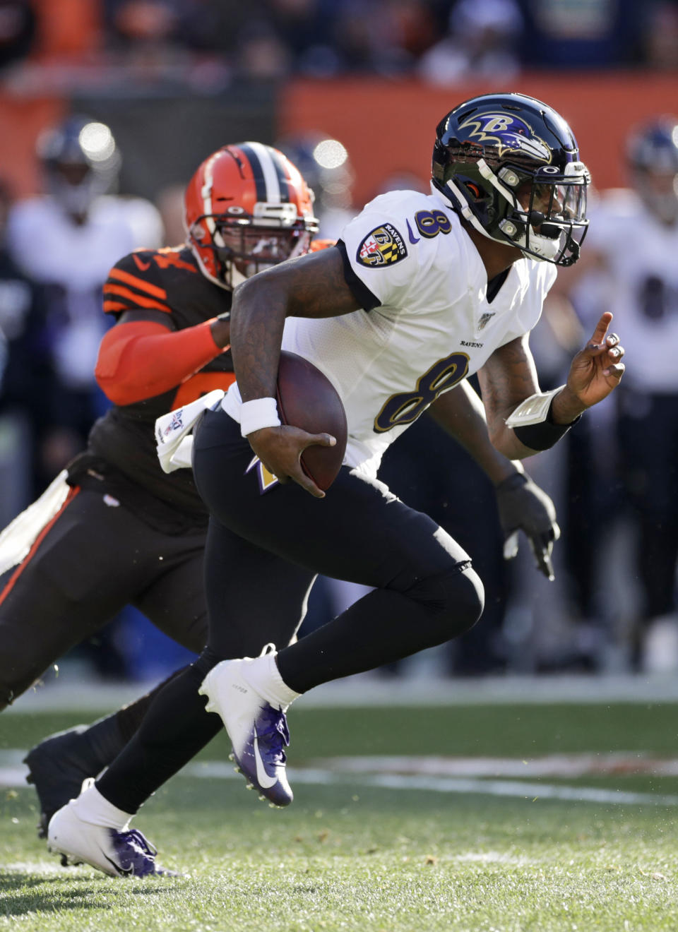 Baltimore Ravens quarterback Lamar Jackson rushes against the Cleveland Browns during the first half of an NFL football game, Sunday, Dec. 22, 2019, in Cleveland. (AP Photo/Ron Schwane)