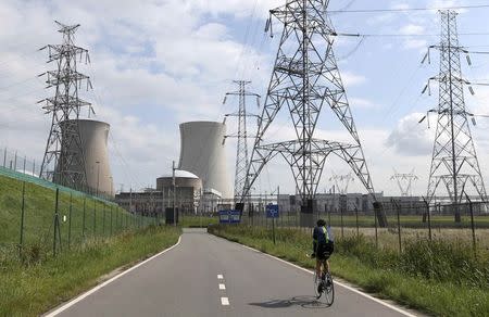 A man cycles towards Doel's nuclear plant, northern Belgium August 20, 2014. REUTERS/Francois Lenoir