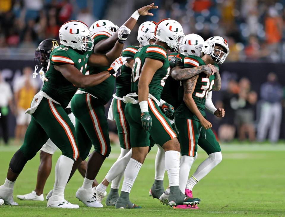 Miami Hurricanes place kicker Andres Borregales (30) celebrate with teammates after making a go-ahead field goal during the fourth quarter of their ACC football game at Hard Rock Stadium on Saturday, September 11, 2021 in Miami Gardens, Florida.