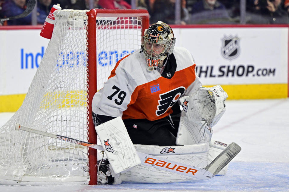 FILE - Philadelphia Flyers' goaltender Carter Hart guards the net during an NHL hockey game against the Colorado Avalanche, Jan. 20, 2024, in Philadelphia. Four current members of the National Hockey League charged with sexual assault in Canada will become free agents after not receiving qualifying offers from their respective teams. Hart was under contract with Philadelphia, Michael McLeod and Cal Foote with New Jersey and Dillon Dube with Calgary when they were charged in connection with an incident that occurred in London, Ontario, in 2018 after they were teammates on Canada's world junior team. (AP Photo/Derik Hamilton, File)