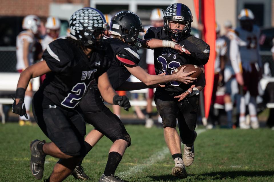 Blackstone Valley Tech sophomore quarterback Alex Vosburgh hands off to sophomore running back Adam Fransen during a Division 6 state football quarterfinal Saturday at Postma Field in Upton.