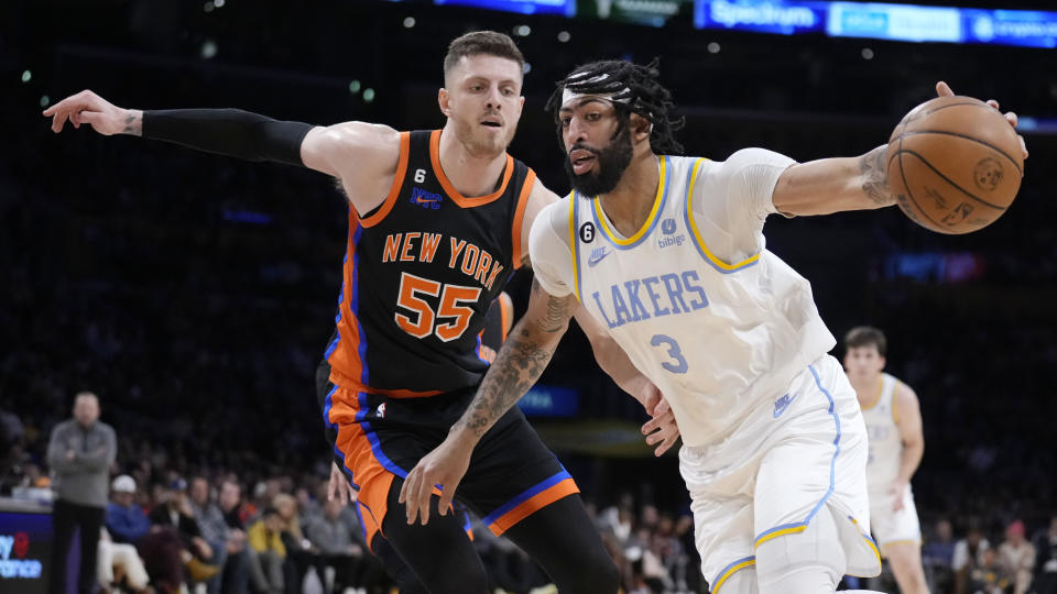 Los Angeles Lakers forward Anthony Davis (3) is defended by New York Knicks center Isaiah Hartenstein (55) during the first half of an NBA basketball game Sunday, March 12, 2023, in Los Angeles. (AP Photo/Marcio Jose Sanchez)