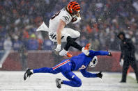 Cincinnati Bengals tight end Hayden Hurst (88) leaps over Buffalo Bills safety Jaquan Johnson (4) during the third quarter of an NFL division round football game, Sunday, Jan. 22, 2023, in Orchard Park, N.Y. (AP Photo/Joshua Bessex)