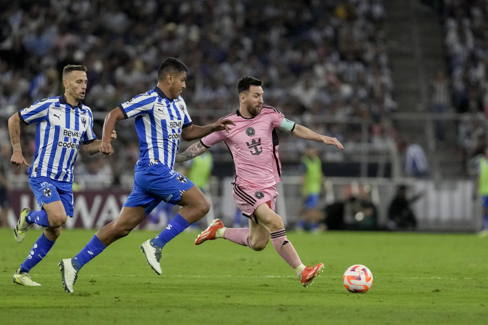 Inter Miami's Lionel Messi, right, tries control the ball past Monterrey's Luis Romo during a CONCACAF Champions Cup quarter final second leg soccer match at the BBVA stadium in Monterrey, Mexico, Wednesday, April 10, 2024. (AP Photo/Eduardo Verdugo)