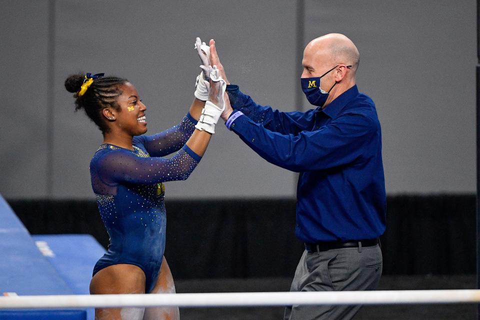 University of Michigan Wolverines gymnast Sierra Brooks and assistant coach Scott Sherman during the 2021 NCAA Women Gymnastics Championships at Dickies Arena.