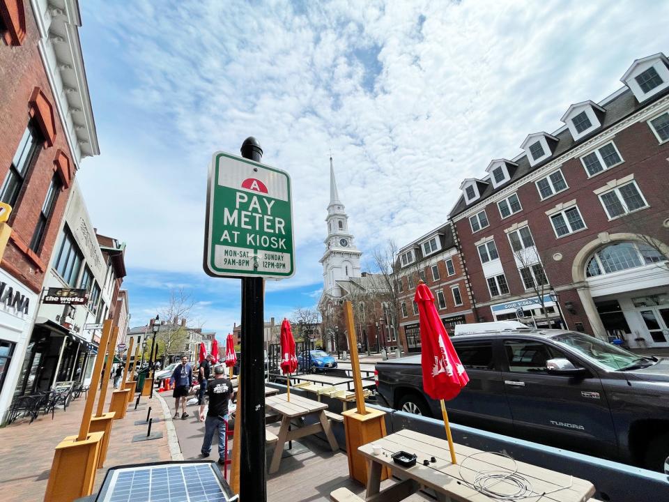 The Thirsty Moose in Portsmouth's Market Square is setting up for outdoor dining as people try to find places to park during lunchtime Monday, April 29, 2024.
