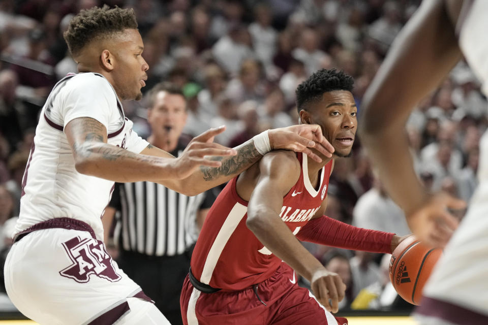 Alabama forward Brandon Miller, right, drives the lane against Texas A&M guard Dexter Dennis, left, during the first half of an NCAA college basketball game Saturday, March 4, 2023, in College Station, Texas. (AP Photo/Sam Craft)