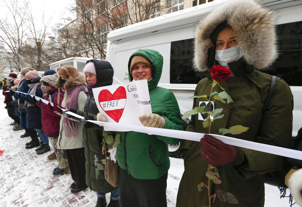 Women, some of them wearing face masks to protect against coronavirus, attend a rally in support of jailed opposition leader Alexei Navalny, and his wife Yulia Navalnaya in Moscow, Russia, Sunday, Feb. 14, 2021. The weekend protests in scores of cities last month over Navalny’s detention represented the largest outpouring of popular discontent in years and appeared to have rattled the Kremlin. (AP Photo/Alexander Zemlianichenko)