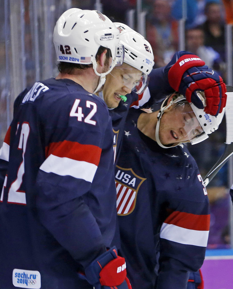 USA forward James van Riemsdyk congratulates USA defenseman Cam Fowler after Fowler scored a goal against Russia in the second period of a men's ice hockey game at the 2014 Winter Olympics, Saturday, Feb. 15, 2014, in Sochi, Russia. (AP Photo/Mark Humphrey)