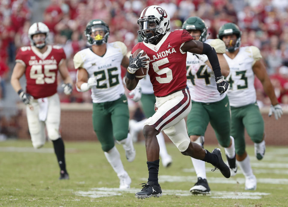 FILE - In this Sept. 29, 2018, file photo, Oklahoma wide receiver Marquise Brown (5) runs ahead of Baylor in the second half of a game in Norman, Okla. Brown was named to the 2018 AP All-America NCAA college football team, Monday, Dec. 10, 2018.(AP Photo/Alonzo Adams, File)