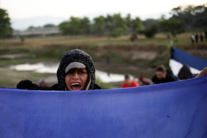 Migrants, mainly from Central America, marching in a caravan walk after crossing the Suchiate river, in the outskirts of Ciudad Hidalgo