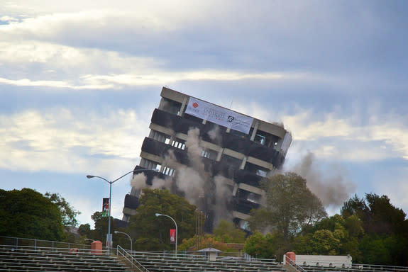 Warren Hall implodes on the campus of Cal State East Bay in Hayward, Calif., on Aug. 17, 2013.