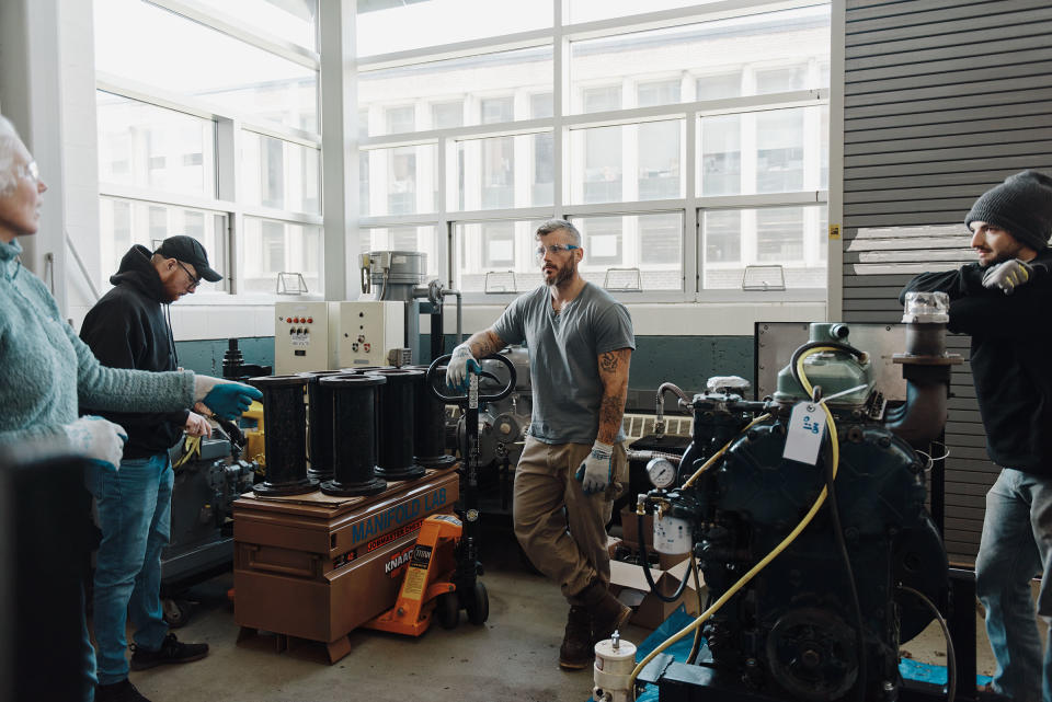 Paul Doolan, Nick Fileccia, and Gerard Mullin during an exercise about moving heavy equipment with instructor Megan Amsler.<span class="copyright">Tony Luong for TIME</span>