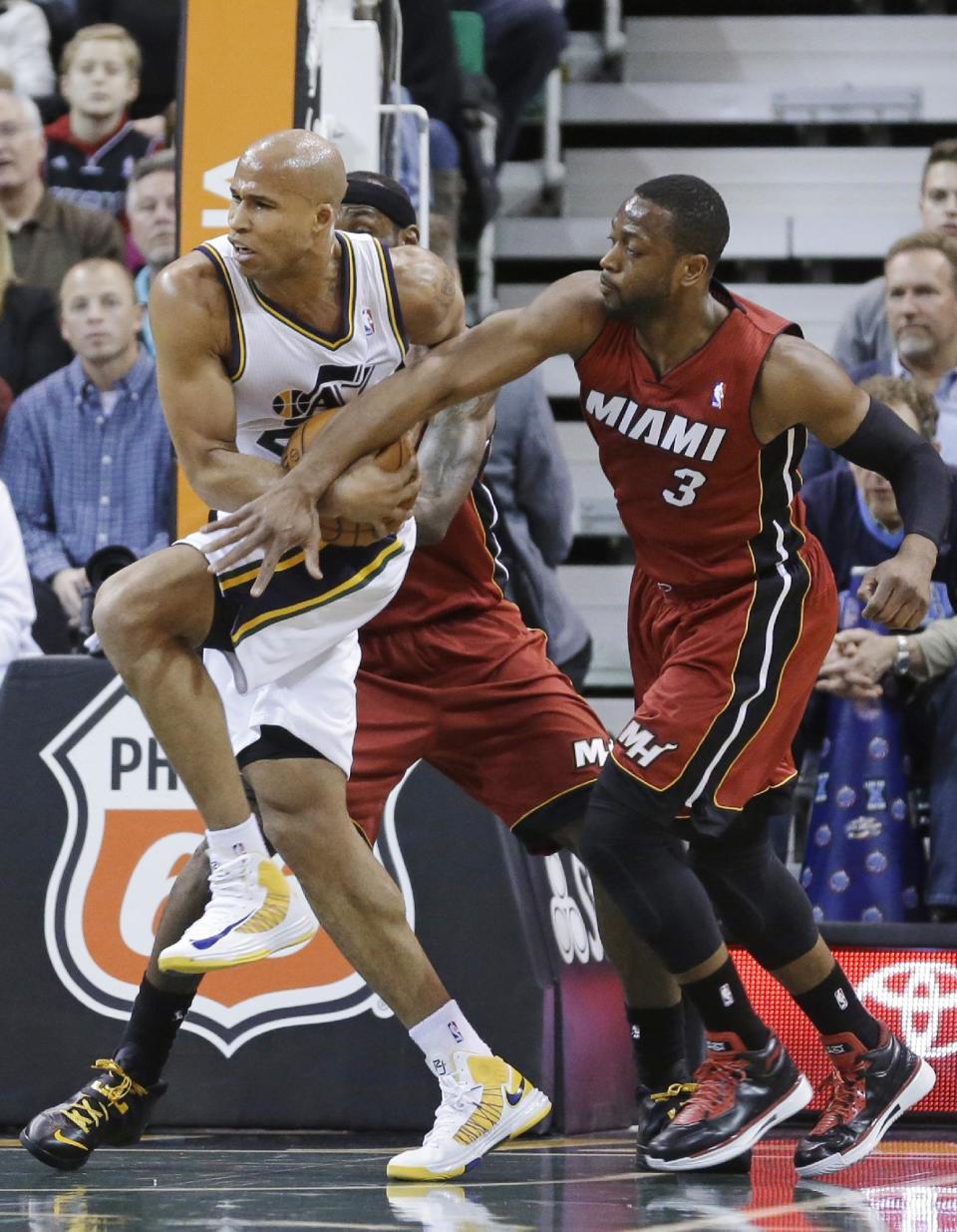 Miami Heat's Dwyane Wade (3) defends Utah Jazz's Richard Jefferson, during the first quarter of an NBA basketball game Saturday, Feb. 8, 2014, in Salt Lake City. (AP Photo/Rick Bowmer)