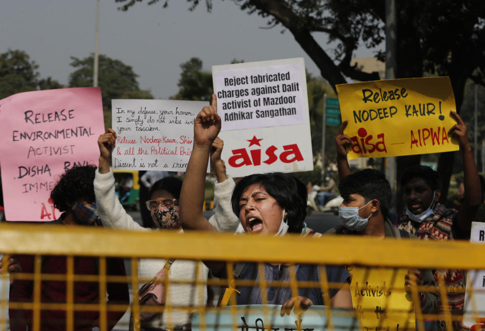 Indian students shout slogans demanding the release of Dalit labor rights activists Nodeep Kaur and Shiv Kumar and climate activist Disha Ravi during a protest in New Delhi, India, Monday, Feb.15 2021. Kaur and Kumar were arrested by police in January on a series of charges while Ravi was arrested Saturday for circulating a document on social media that allegedly incited protesting farmers to turn violent last month. (AP Photo/Manish Swarup)