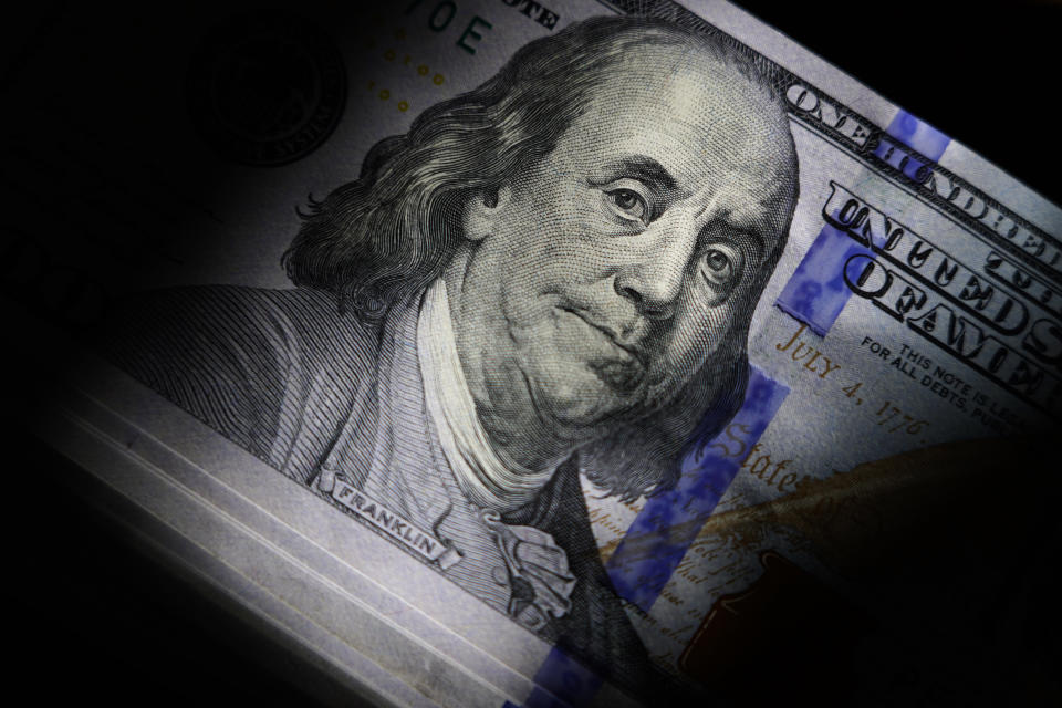 File - The likeness of Benjamin Franklin is seen on U.S. $100 bills, Thursday, July 14, 2022, in Marple Township, Pa. If the debt crisis now roiling Washington were eventually to send the United States crashing into recession, the repercussions of a first-ever default on the federal debt would reverberate around the world and quickly. (AP Photo/Matt Slocum, File)