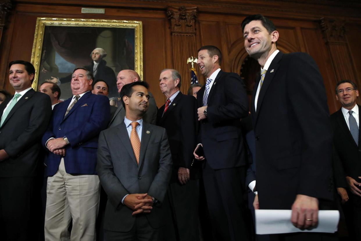 House Speaker Paul Ryan smiles as he arrives to speak to the media with House Republicans following passage of the GOP tax overhaul (AP Photo/Jacquelyn Martin): AP