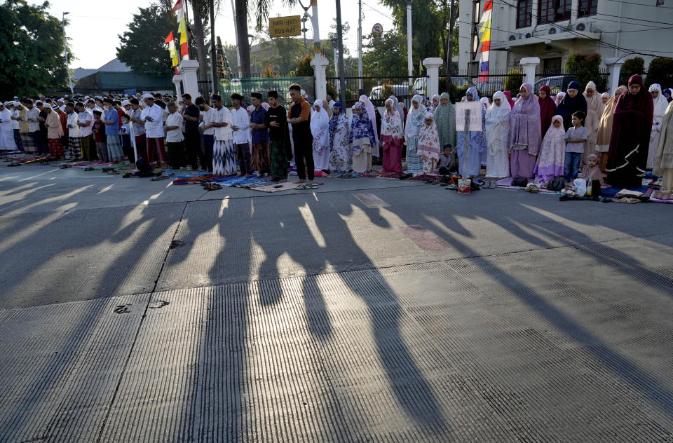 Muslims perform a morning prayer marking the Eid al-Adha holiday on a street in Jakarta, Indonesia, Sunday, July 10, 2022. Muslims around the world will celebrate Eid al-Adha, or Festival of Sacrifice, slaughtering sheep, goats, cows and camels to commemorate Prophet Abraham's readiness to sacrifice his son Ismail on God's command. (AP Photo/Tatan Syuflana)