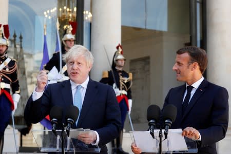 French President Emmanuel Macron and British Prime Minister Boris Johnson deliver a joint statement before a meeting on Brexit at the Elysee Palace in Paris