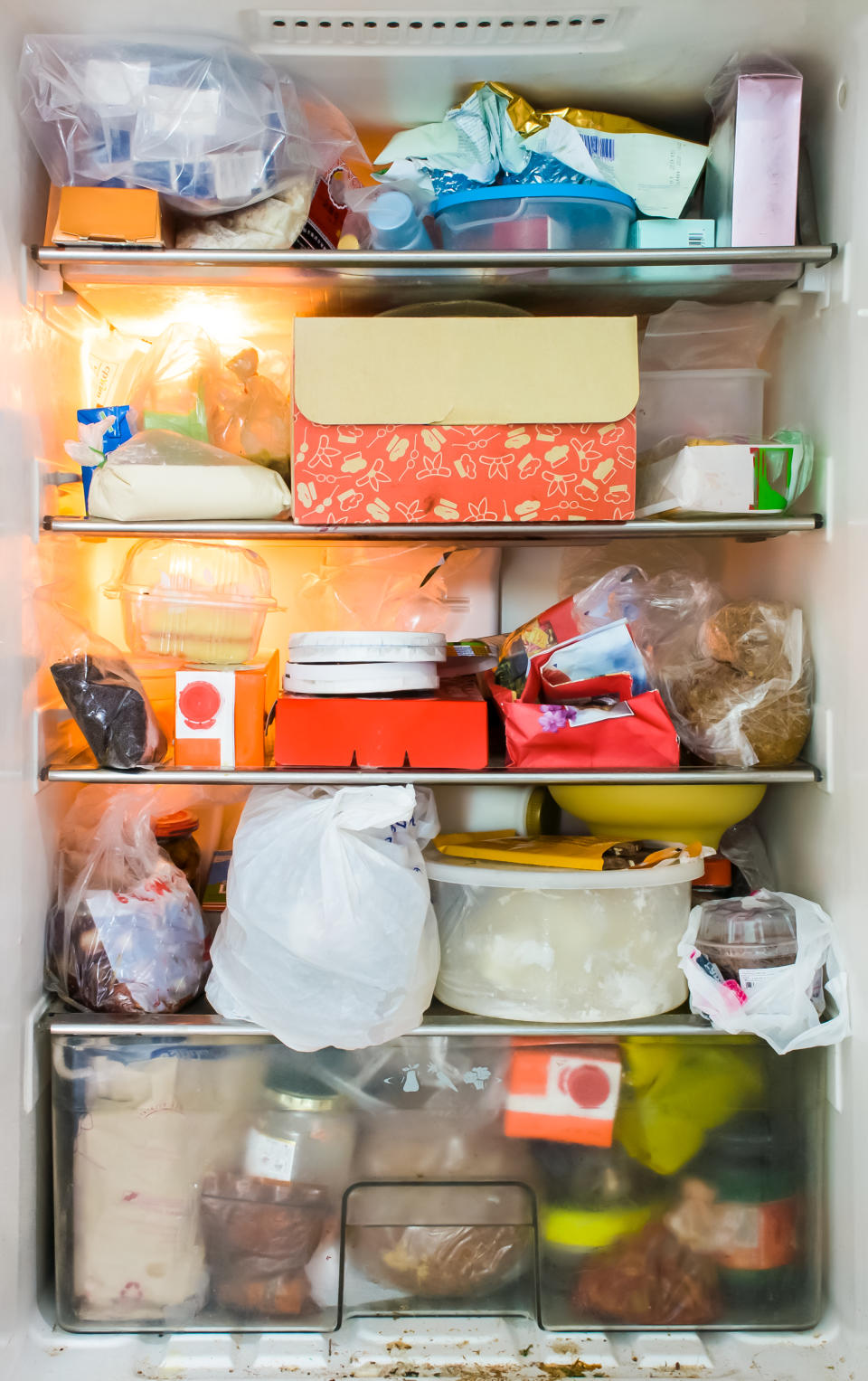 Pictured is a fridge fully stocked with old food. 