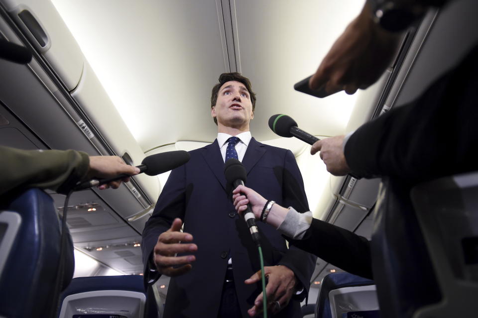 Canadian Prime Minister and Liberal Party leader Justin Trudeau makes a statement in regards to a photo coming to light of himself from 2001, wearing "brownface," during a scrum on his campaign plane in Halifax, Nova Scotia, Wednesday, Sept. 18, 2019. (Sean Kilpatrick/The Canadian Press via AP)