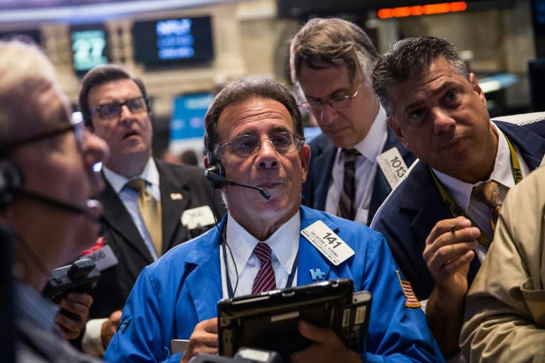 Traders work on the floor of the New York Stock Exchange during the morning of August 27, 2015