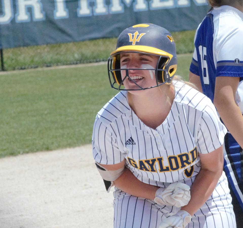 Alexis Kozlowski celebrates after hitting a triple during the MHSAA Division 2 district semifinal game with Gladwin on Saturday, June 4 at Petoskey High School.