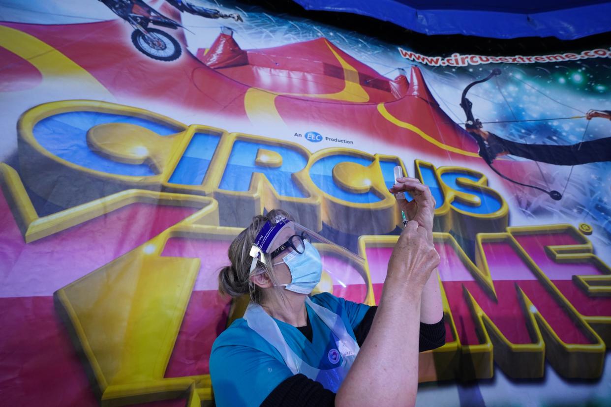 A doctor prepares a syringe at a pop-up Covid-19 vaccination clinic in the marquee of Circus Extreme in Halifax (Owen Humphreys/PA) (PA Wire)