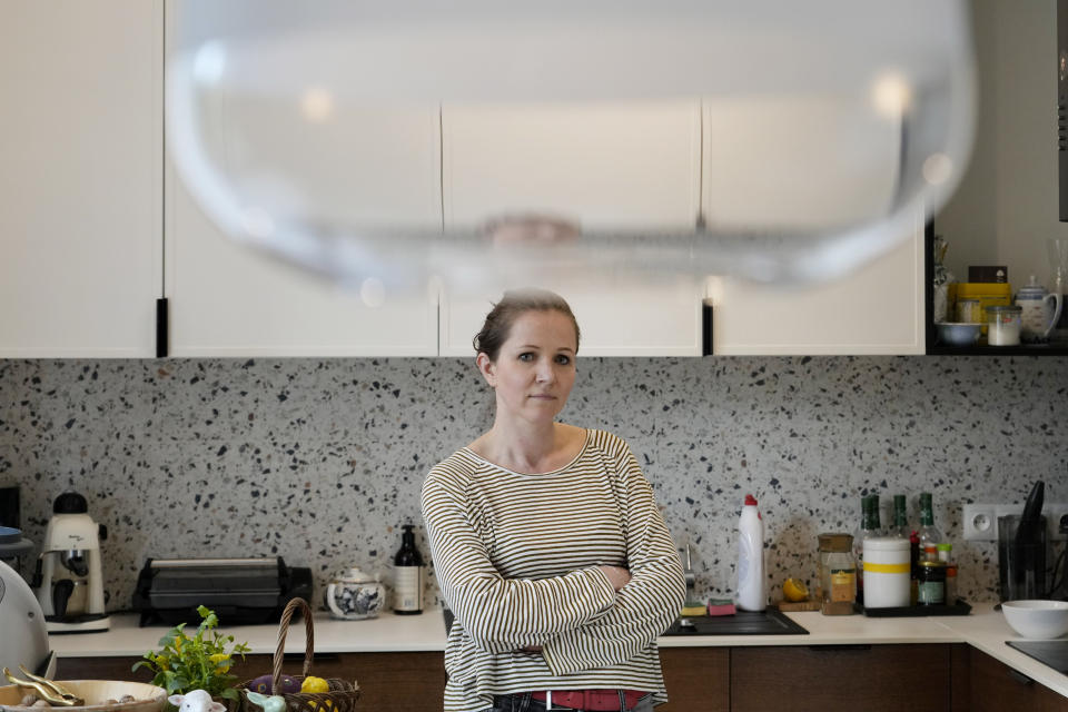 Magda Kozak, mother of three, stands at her home in Warsaw, Poland, Friday, April 5, 2024. Magda and her husband Pawel have different opinions on the decision by Poland's government that ordered strict limits on the amount of homework that teachers can impose on the lower grades, starting in April. (AP Photo/Czarek Sokolowski)