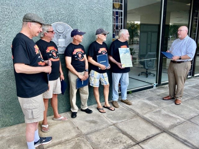 Gainesville Mayor Harvey Ward, right, presents a proclamation to the group known as "the Gainesville Eight," on Friday, Aug. 25, 2023