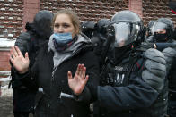 Police officers detain a young demonstrator during a protest near the Matrosskaya Tishina prison where Alexei Navalny is being held, in Moscow, Russia, on Sunday, Jan. 31, 2021. Chanting slogans against President Vladimir Putin, thousands of people took to the streets Sunday across Russia's vast expanse to demand the release of jailed opposition leader Alexei Navalny, keeping up the nationwide protests that have rattled the Kremlin. Over 1,600 were detained by police, according to a monitoring group. (AP Photo/Alexander Zemlianichenko)