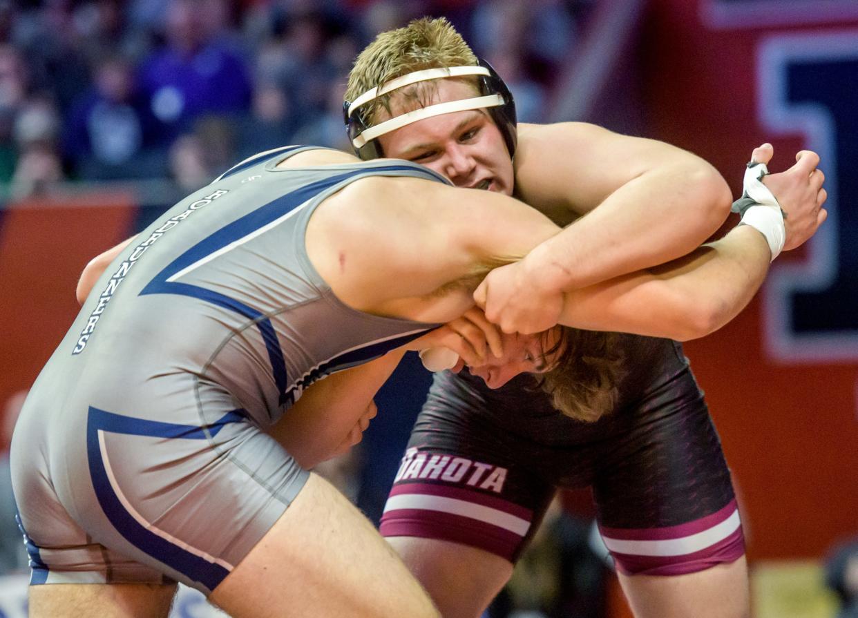 Dakota's Noah Wenzel, top, puts a hold on Nazareth's Gabriel Kaminski in the 220-pound match of the  Class 1A state wrestling tournament Saturday, Feb. 18, 2023 at State Farm Arena in Champaign. Wenzel took the title with a 2-1 decision.