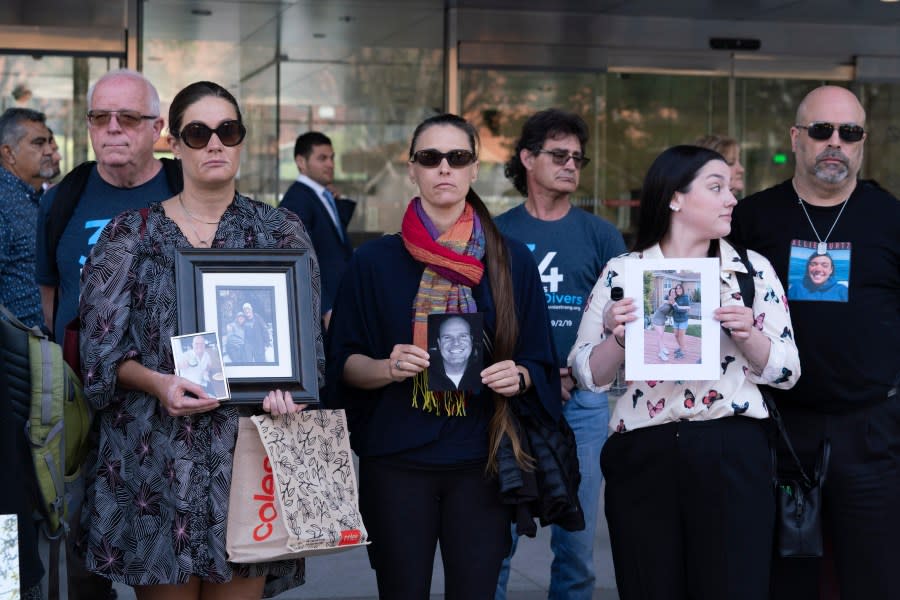 Family members holding photos of their loved ones who died in the Conception dive boat fire leave the U.S. Federal Building in downtown Los Angeles on Thursday, May 2, 2024. A federal judge on Thursday sentenced the scuba dive boat captain, Jerry Boylan to four years in prison and three years supervised release for criminal negligence after 34 people died in a fire aboard the vessel. (AP Photo/Richard Vogel)