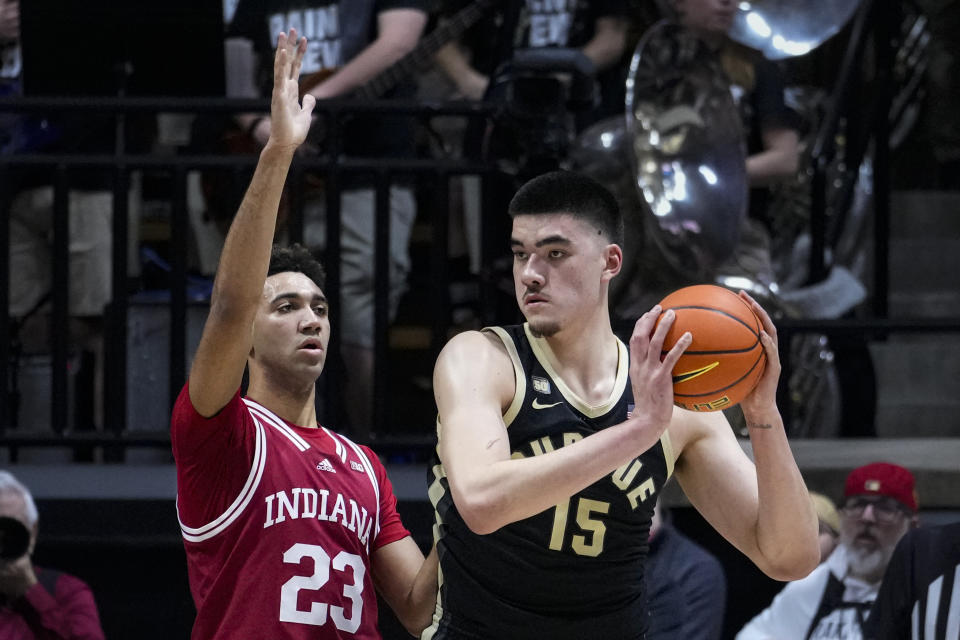 Indiana forward Trayce Jackson-Davis (23) defends Purdue center Zach Edey (15) during the first half of an NCAA college basketball game in West Lafayette, Ind., Saturday, Feb. 25, 2023. (AP Photo/Michael Conroy)